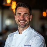 Oliver Bennett, commercial catering equipment specialist, smiling in a sharp suit. Posed in a modern kitchen showroom, he looks professional and trustworthy.
