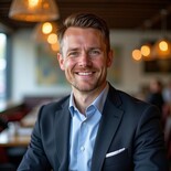 Thomas Keane, restaurant furniture and storage expert, dressed smartly in a navy blazer. Seated in a stylish restaurant, ready to advise on space and seating.